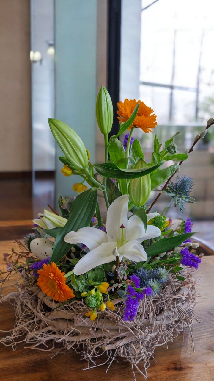 Vibrant modern fresh flower  arrangement in willow ring