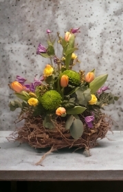 Easter arrangement in purple orange and zesty lime green