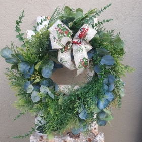 Mixed foliage wreath driving home for Christmas ribbon
